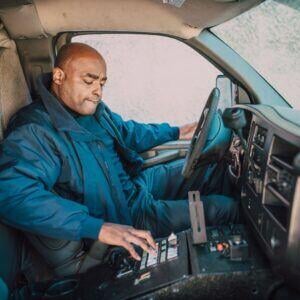 fleet driver pressing buttons in vehicle