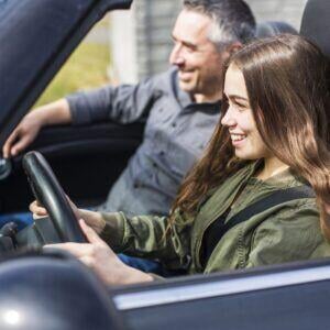 father driving with daughter